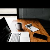 Office desk with laptop and notepad